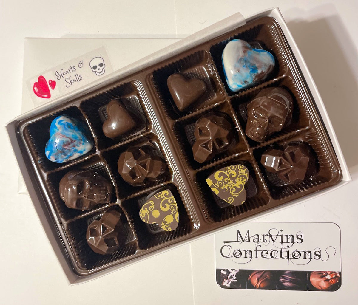 Hearts and Skulls 12-Piece Valentine's Day Gift Box. This devastatingly deliciously dark collection includes cookie butter, maple pecan cinnamon, and penuche--everything to make your Valentine swoon.  Marvin's Confections based in Charlotte, North Carolina.